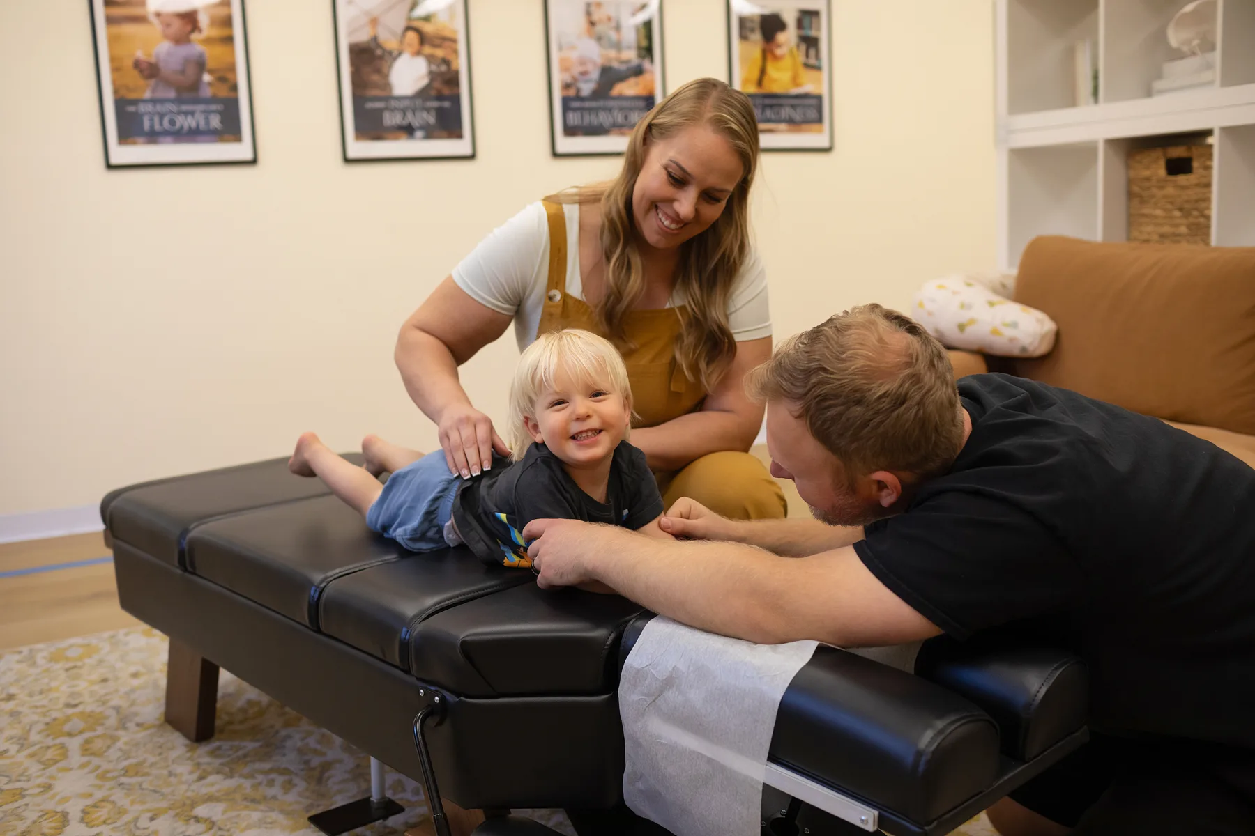 A smiling child with family during a visit at Taproot Chiropractic