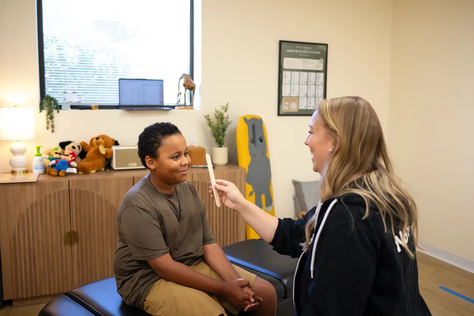 Dr. Jennifer meeting with a teen patient at Taproot Chiropractic