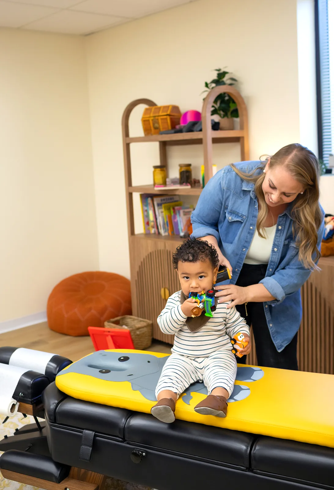 Dr. Jennifer caring for a young child at Taproot Chiropractic
