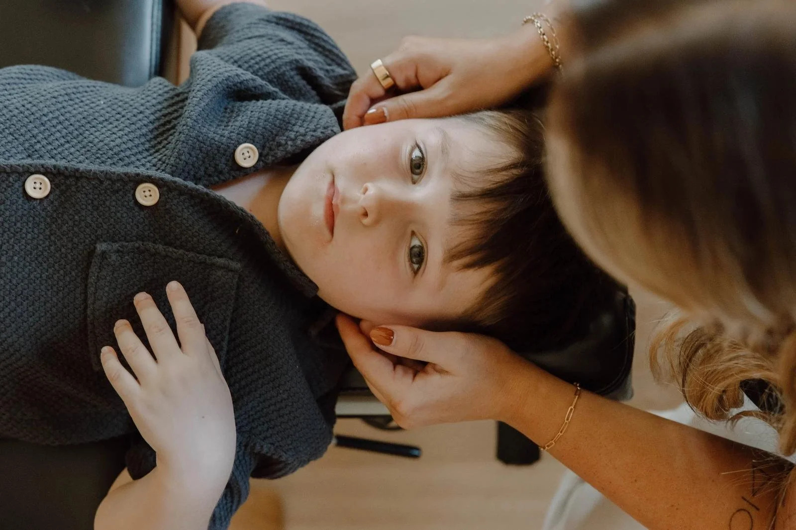 Chiropractor gently supporting a child's head and neck