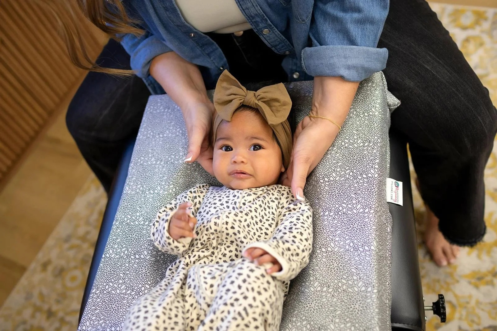 Dr. Jennifer Gordon gently supporting an infant’s head and neck during an assessment