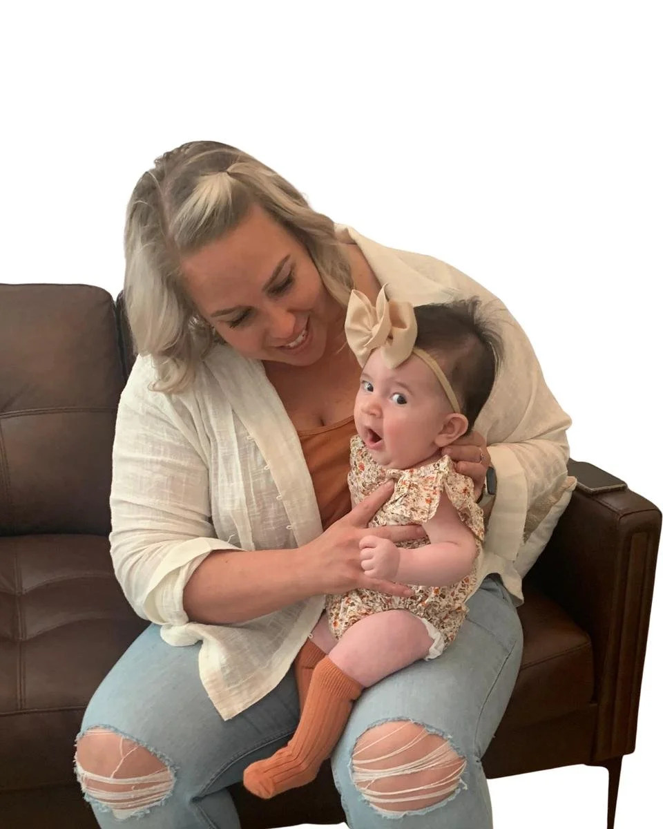 Mother holding and comforting her infant while seated