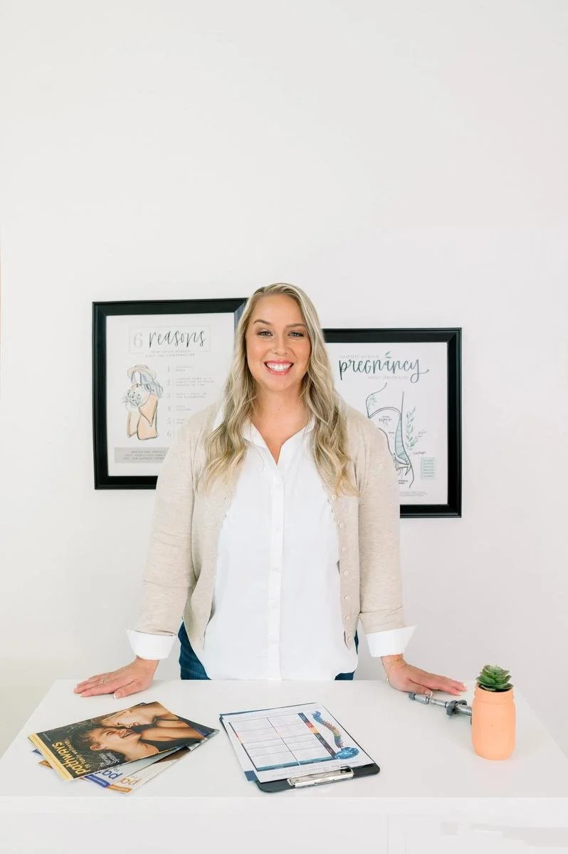 Dr. Jennifer Gordon standing at a table with printed materials