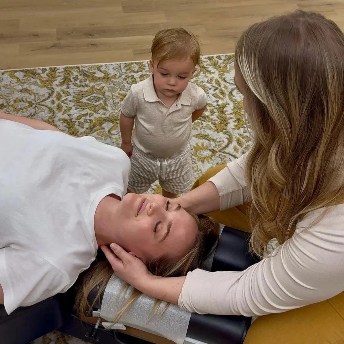 Dr. Jennifer Gordon gently adjusting a patient's head and neck