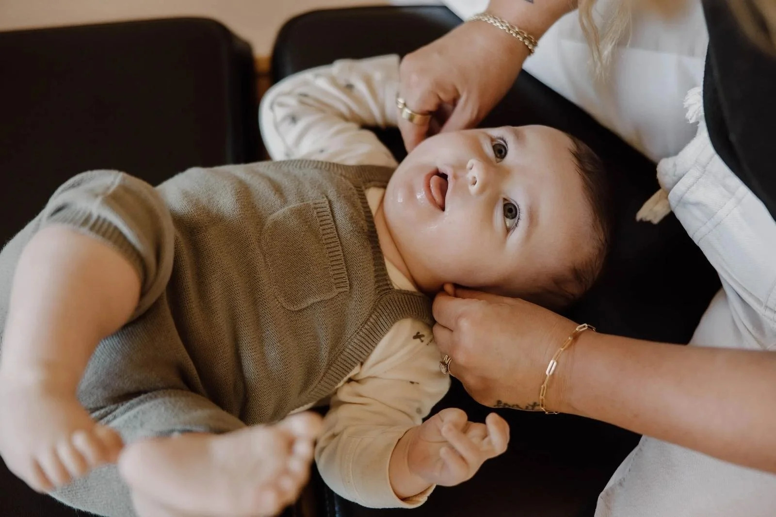 Dr. Jennifer Gordon holding and adjusting a baby's jaw/neck area