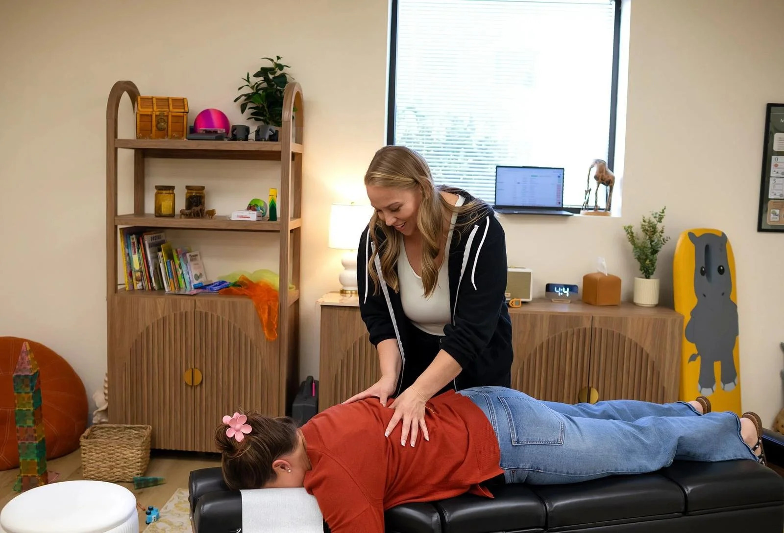 Dr. Jennifer Gordon adjusting a patient on a treatment table